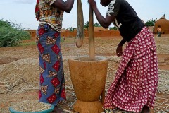 Giovani ragazze Haoussa si alternano nel mortaio per sgranare il sorgo, villaggio Mouja, NIger 2019