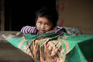 Una bellissima bambina di etnia Tharu punta il suo sguardo disarmante verso l'obiettivo della mia macchina, Villaggio di Sauraha, Chitwan National Park, Nepal 2018