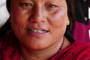 Ritratto di una donna nepalese appartenente all'etnia Gurung: il suo stato di donna sposata è indiscutibilmente palesato dal "Maang" (il segno rosso praticato con il kumkum nella partizione dei capelli) e l'immancabile "Bindi" (che ha funzioni solo decorative ed è usato solamente dalle donne: il suo significato mistico si è perduto nel tempo, divenendo un semplice abbellimento che valorizza il volto conferendo maggiore intensità allo sguardo ed un senso di profonda spiritualità). Pashupatinath, Nepal 2018.