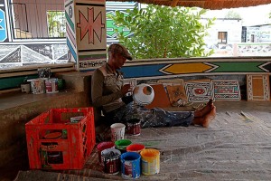 Uomo di etnia Ndbele pratica gli insegnamenti delle proprie donne decorando i vasi di ceramica con antichissime tecniche tramandate di generazione in generazione, Regione Mpulamanga, Villaggio Botshabelo, Sud Africa 2012