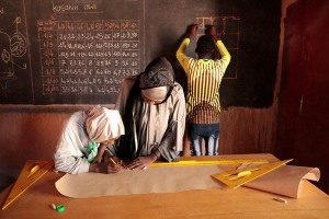 Scuola di sartoria ad Agadez, all'interno della struttura creata dall'Associazione Point d'Appui (Associazione per bambini in difficoltà). Il maestro conduce la lezione ai suoi studenti che appaiono concentrati ed interessati agli argomenti trattati. Niger 2020
