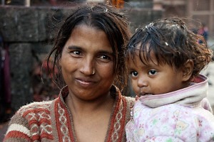 Giovane donna nepalese appartenente agli "Harijan", gli intoccabili, il gradino più basso nella società nepalese a cui vengono delegati i lavori più umili, insieme alla sua bambina, città vecchia di Kathmandu, Nepal 2018