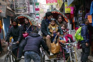 Nelle strette viuzze del caotico quartiere Thamel di Kathmandu, molte famiglie utilizzano i risciò per i propri spostamenti, Nepal 2018.